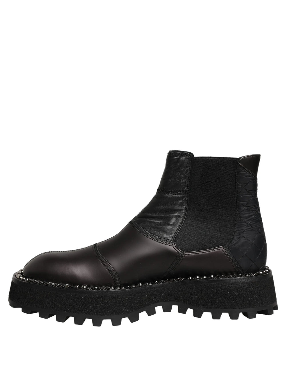 Side profile of Dolce & Gabbana black leather ankle boots showing the refined silhouette and stacked heel.