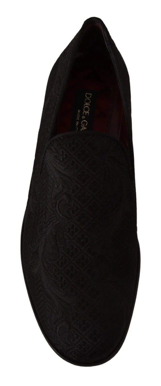 Angled view of the Dolce & Gabbana black brocade loafers, showcasing the light-catching texture of the floral weave.