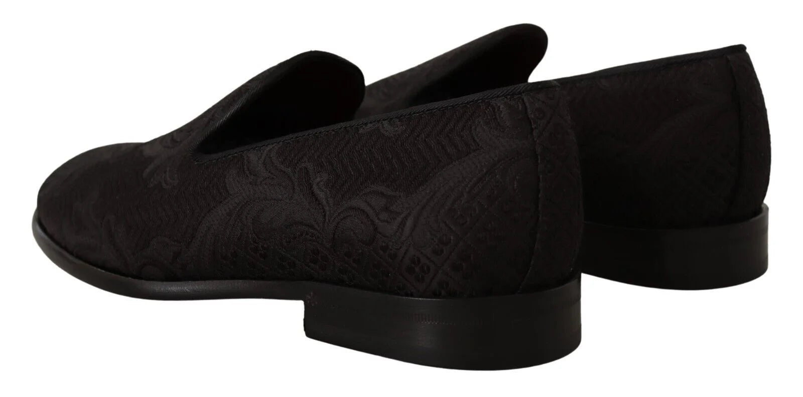 Top-down view of Dolce & Gabbana black loafers featuring a quilted satin lining and gold-tone logo branding.