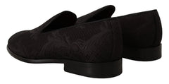 Top-down view of Dolce & Gabbana black loafers featuring a quilted satin lining and gold-tone logo branding.