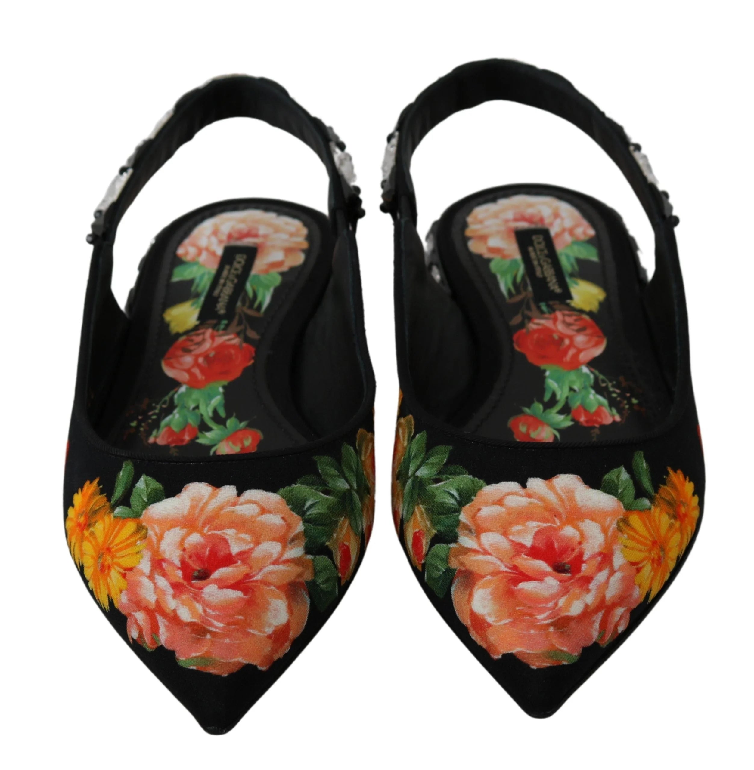 Lähikuva monimutkaisesta kristallikukkakoristeesta ja teksturoidusta viskoosikankaasta Dolce & Gabbana -luksusballerinoissa.