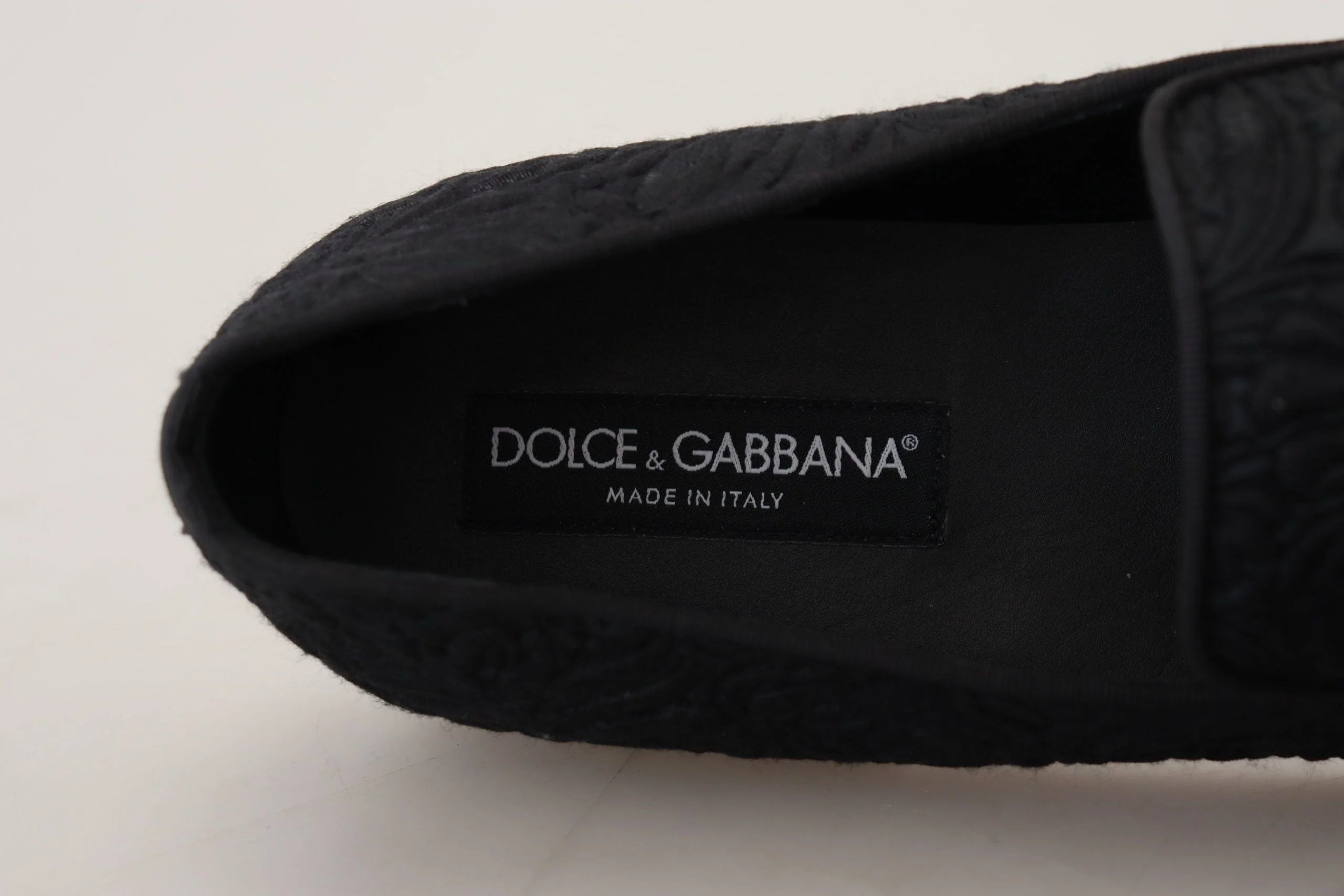 Side profile of Dolce & Gabbana black jacquard loafers showing the sleek evening shoe design and low stacked heel.