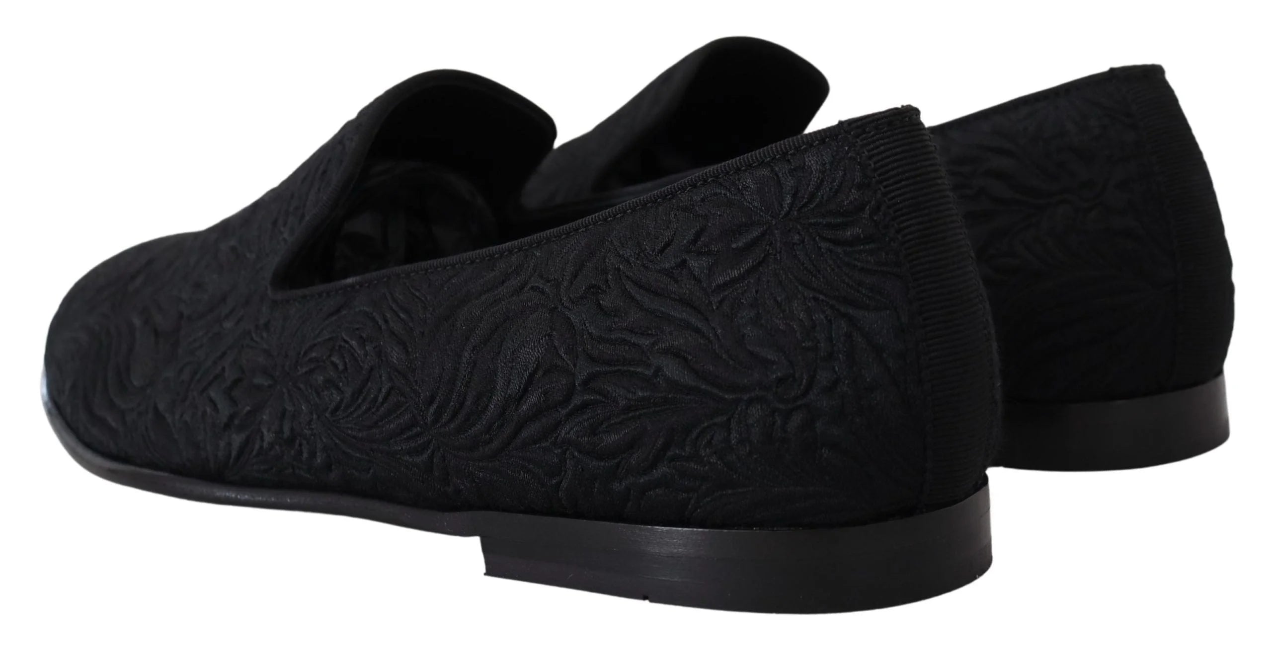 Close-up of the luxurious floral jacquard weave on Dolce & Gabbana slippers, illustrating the fine textile craftsmanship.
