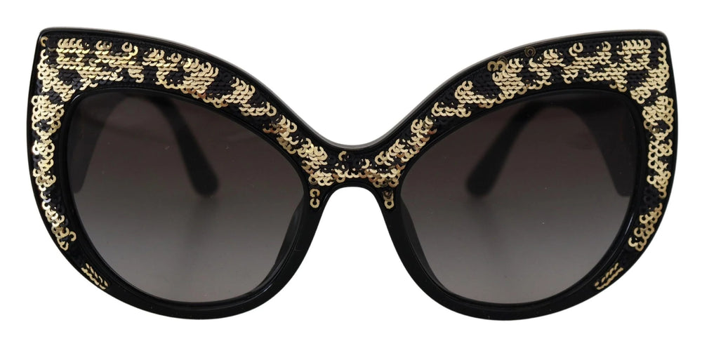 Zbliżenie na motyw pozłacanego motyla i rzemiosło na okularach Dolce & Gabbana DG4326.