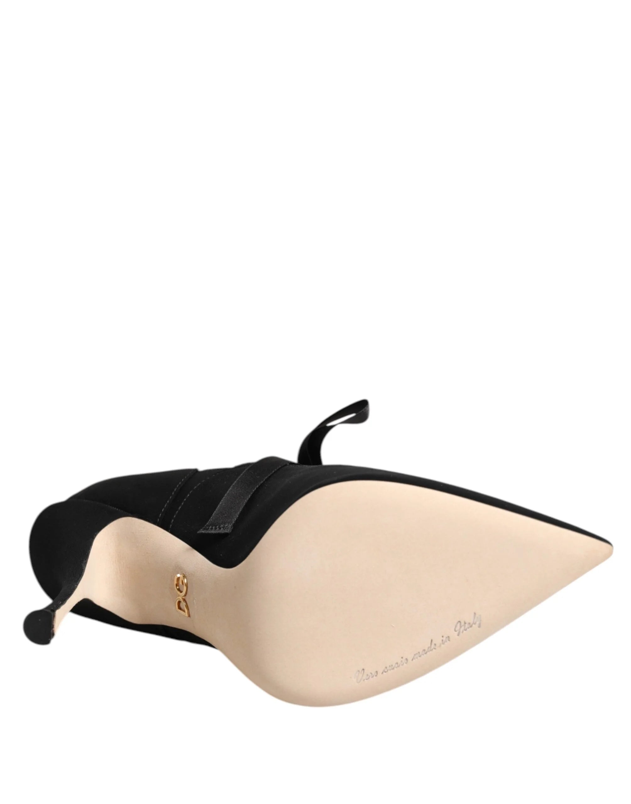 Angled studio shot of the Dolce & Gabbana black lace-up pumps, a testament to understated prestige and style.