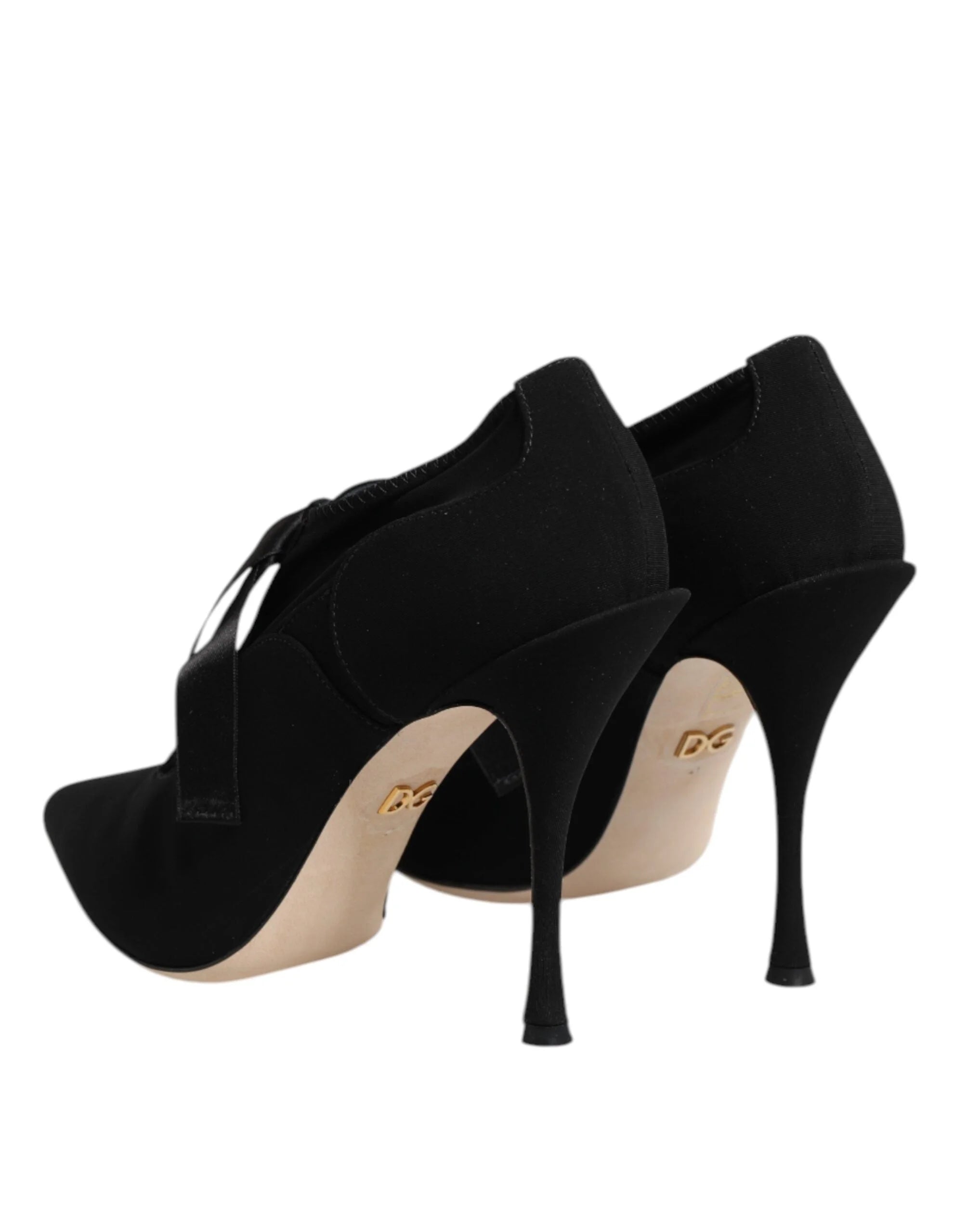 Top-down view of black Dolce & Gabbana pointed-toe pumps with intricate lace-up detailing and branded insoles.