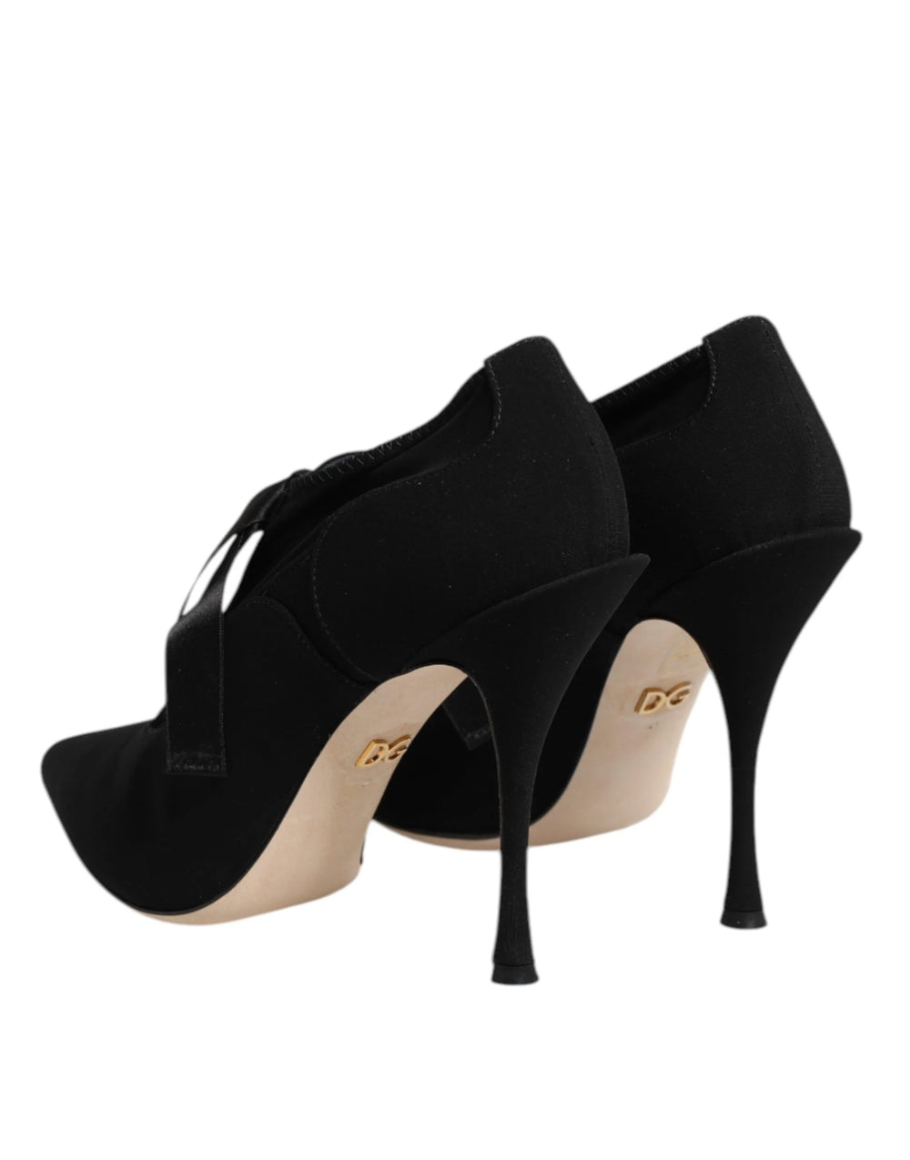 Top-down view of black Dolce & Gabbana pointed-toe pumps with intricate lace-up detailing and branded insoles.