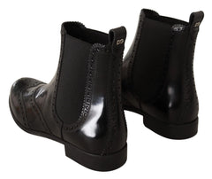 Side profile of Dolce & Gabbana women's flat leather boots in black, showcasing the refined craftsmanship and low heel.