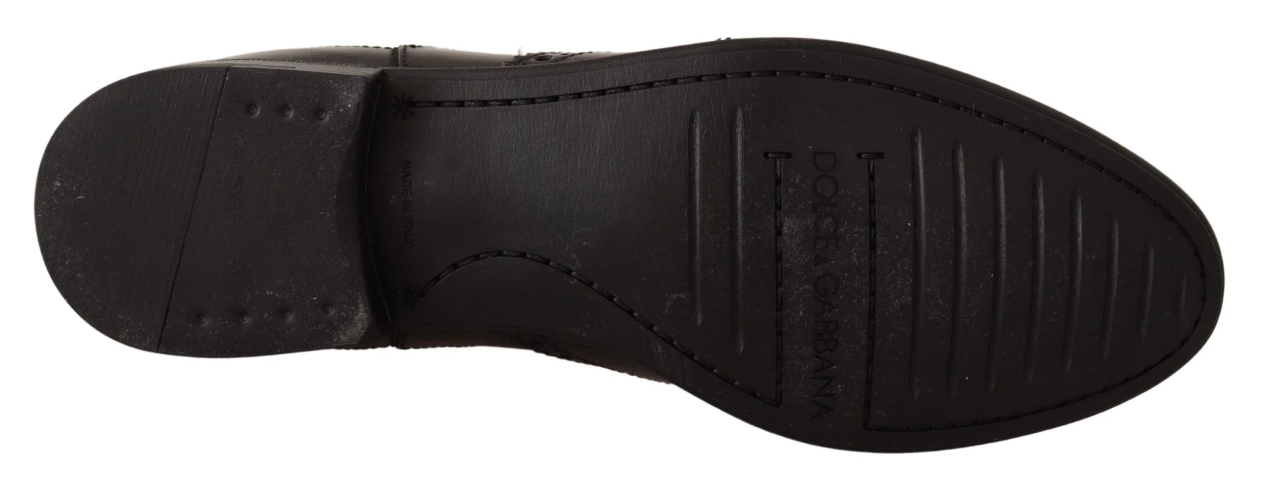 Close-up of the premium black leather texture and tonal stitching on these luxury Dolce & Gabbana ankle boots.