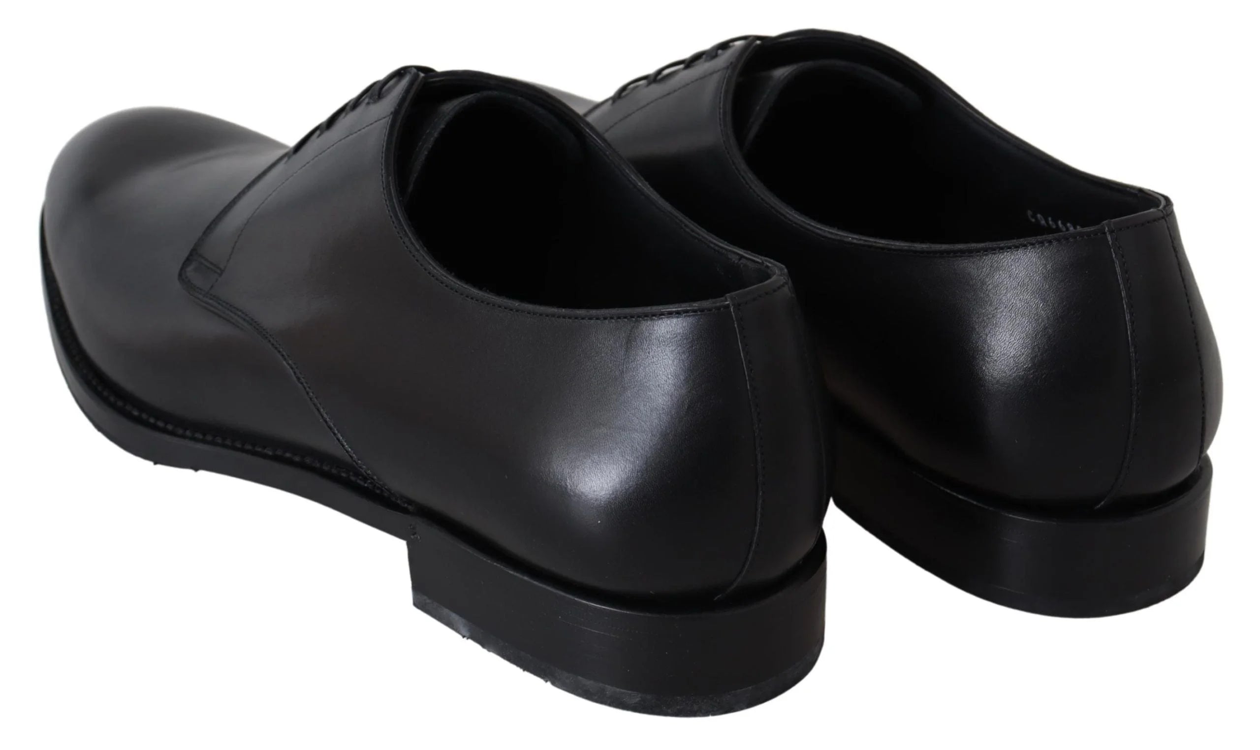 Top-down view of the polished black leather uppers and lacing system of these Dolce & Gabbana formal pumps.