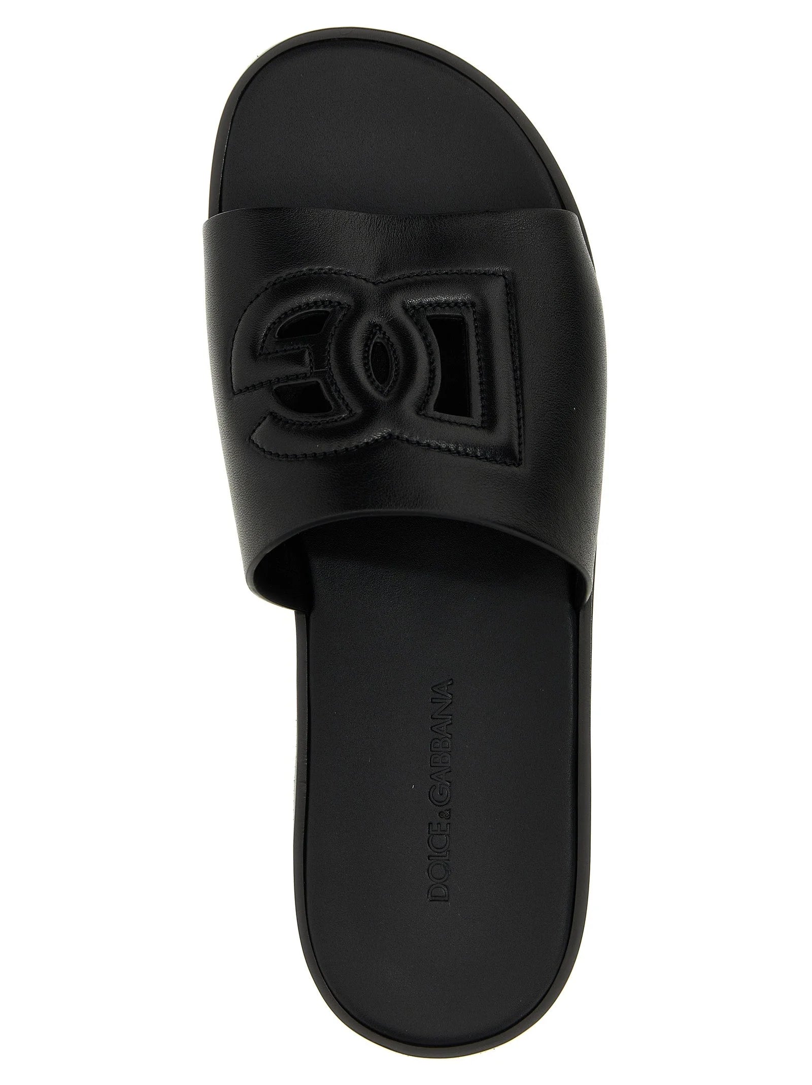 Close-up of the premium leather texture and precise stitching on these Italian-made Dolce & Gabbana luxury slides.