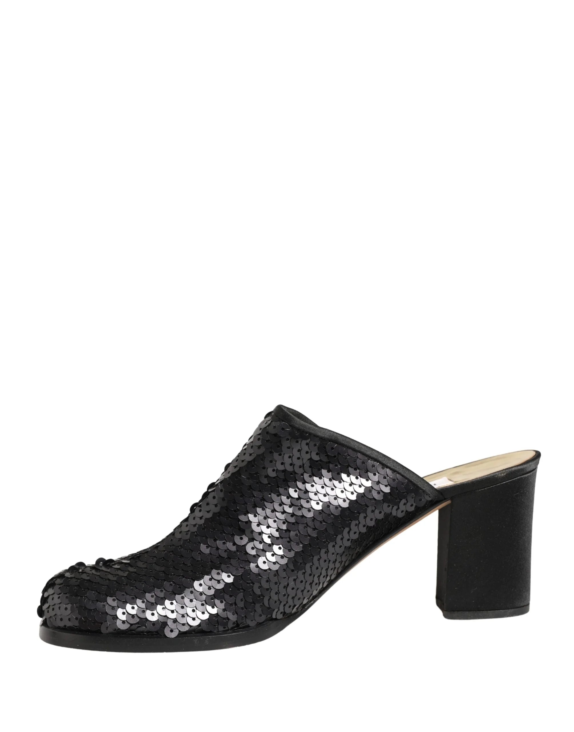 Top-down view of Dolce & Gabbana luxury mules, revealing the branded leather insole and shimmering sequin embellishments.