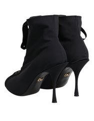 Top-down view of Dolce & Gabbana pointed-toe ankle boots showing the symmetrical lace-up closure and premium leather.