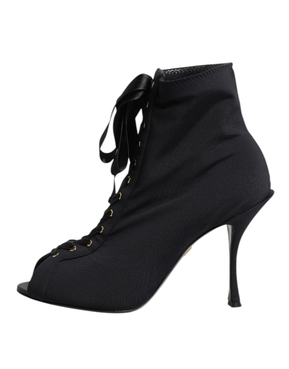 Close-up of the fine leather texture and precision stitching on Dolce & Gabbana black lace-up stiletto boots.
