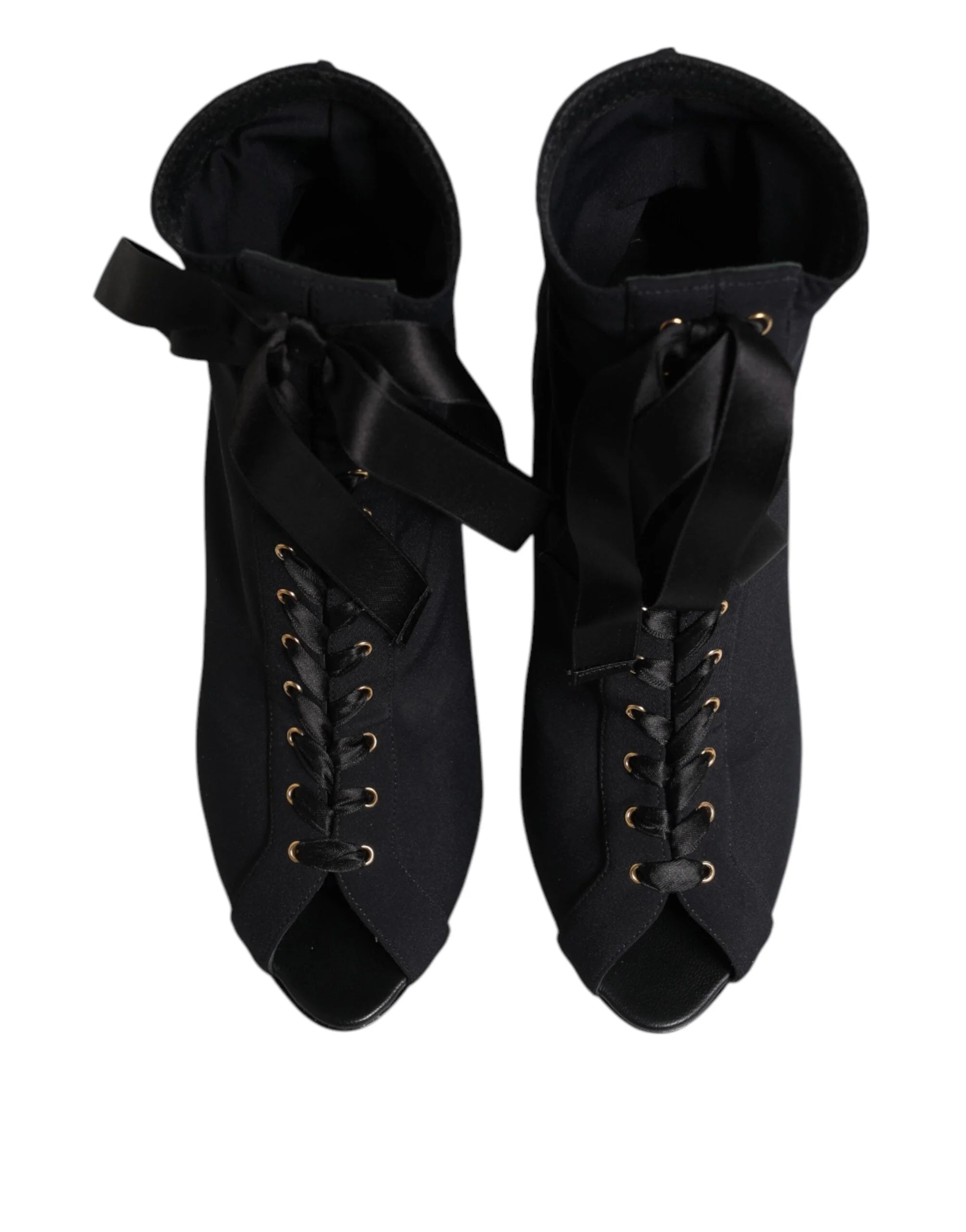 Side profile of Dolce & Gabbana stiletto ankle boots in black leather with intricate lacing and a slim high heel.