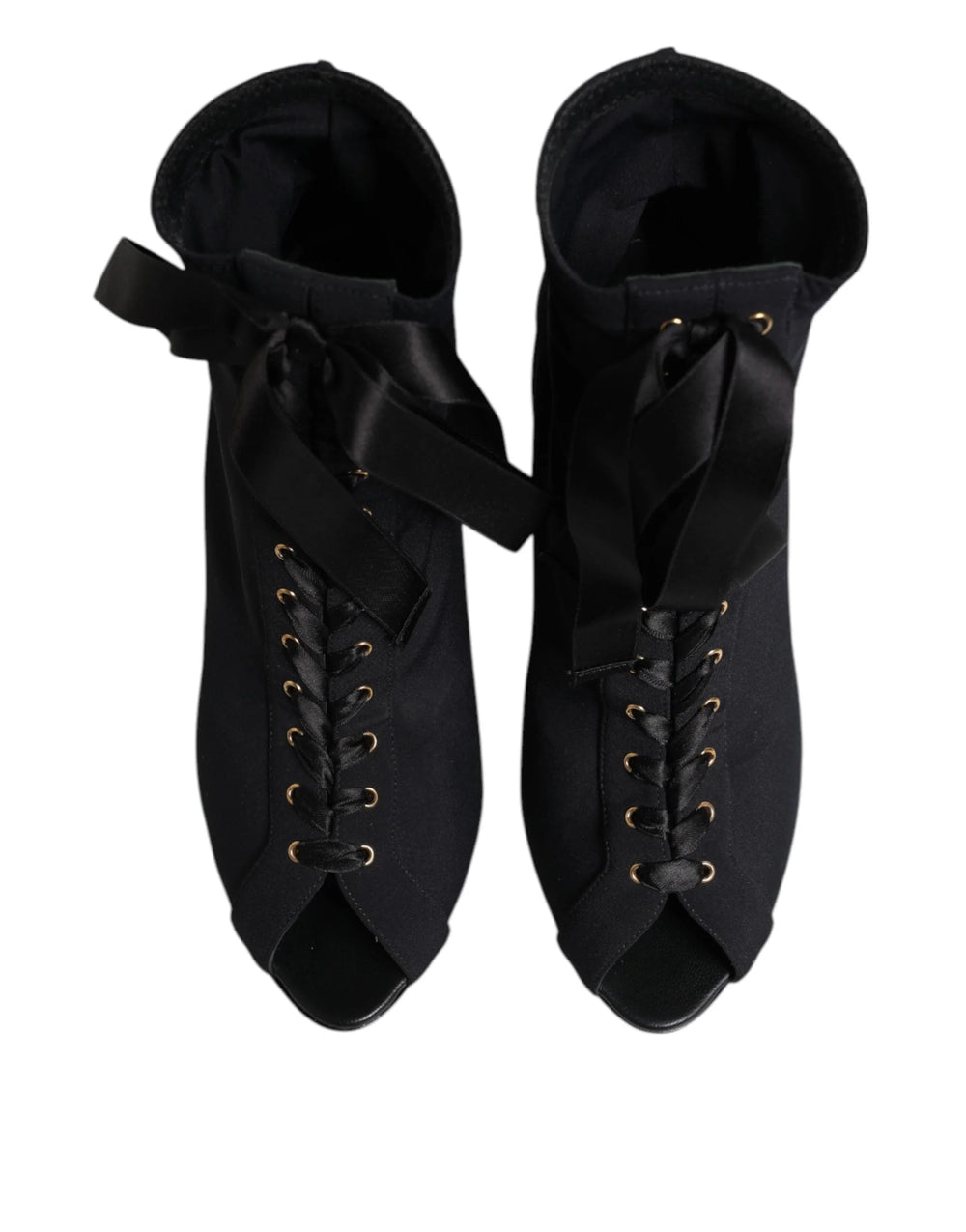 Side profile of Dolce & Gabbana stiletto ankle boots in black leather with intricate lacing and a slim high heel.
