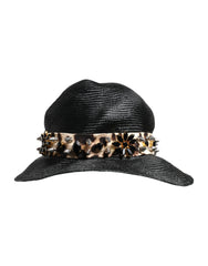 כובע קש שחור רחב שוליים של Dolce & Gabbana עם סרט מקושט ביהלומים לאסתטיקה קיצית מתוחכמת.