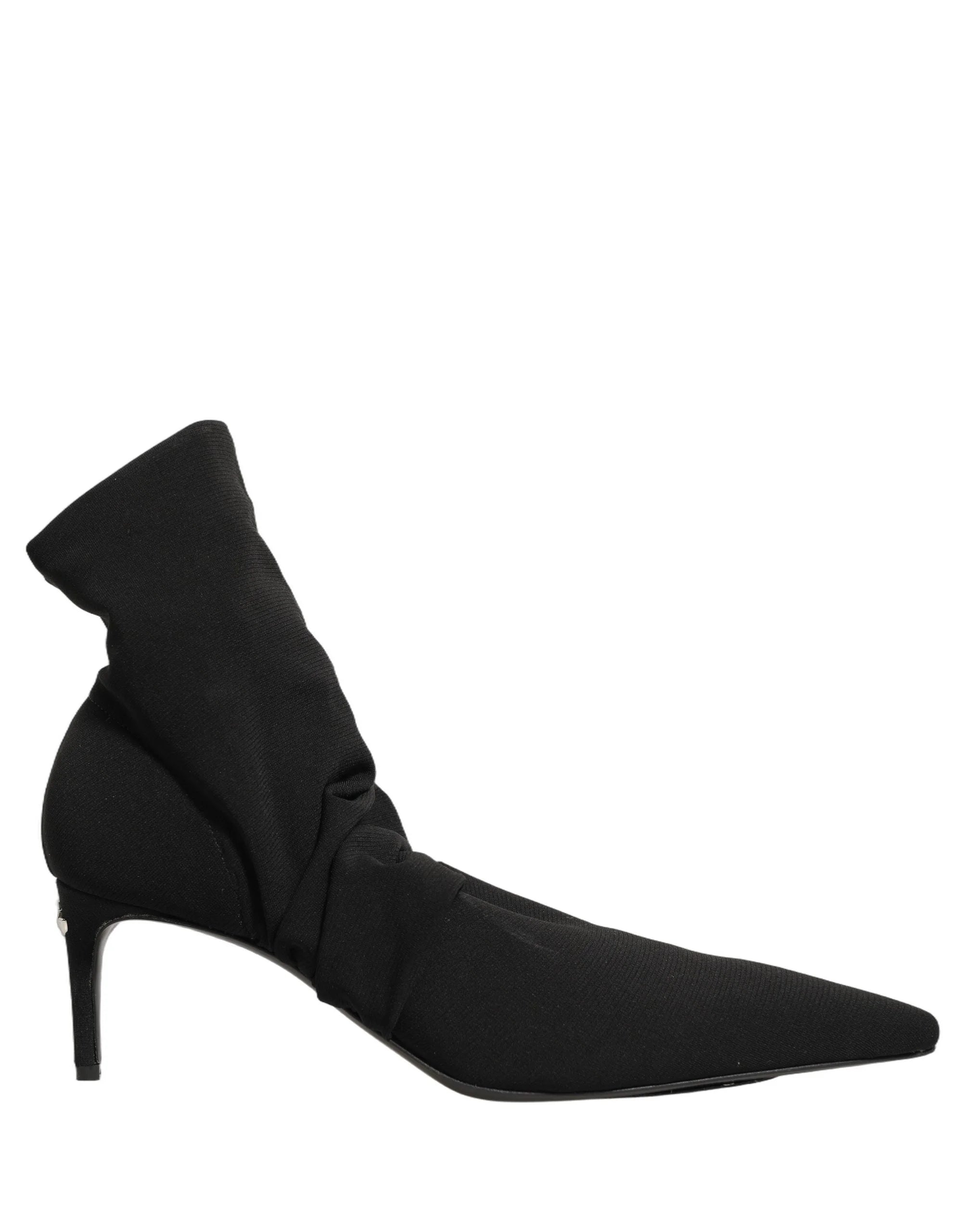 Detalii ale călcâiului și tălpii întărite ale acestor pantofi de șosete negri Dolce & Gabbana de lux.