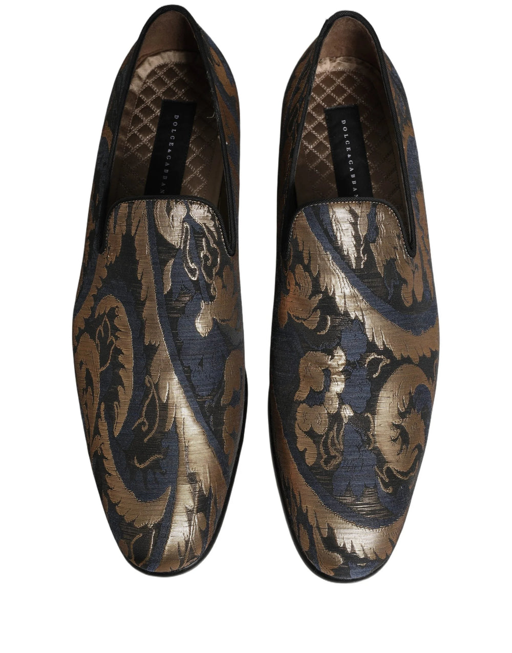 Baggrundsbillede af Dolce & Gabbana luksus loafers, der viser det blå mønstrede stof og den forstærkede hælkonstruktion.