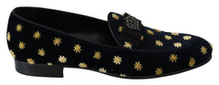 Side profile of Dolce & Gabbana blue velvet loafers showing the elegant silhouette and low stacked heel.
