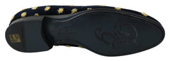 Close-up of the intricate gold thread crown embroidery on the plush blue cotton velvet upper.