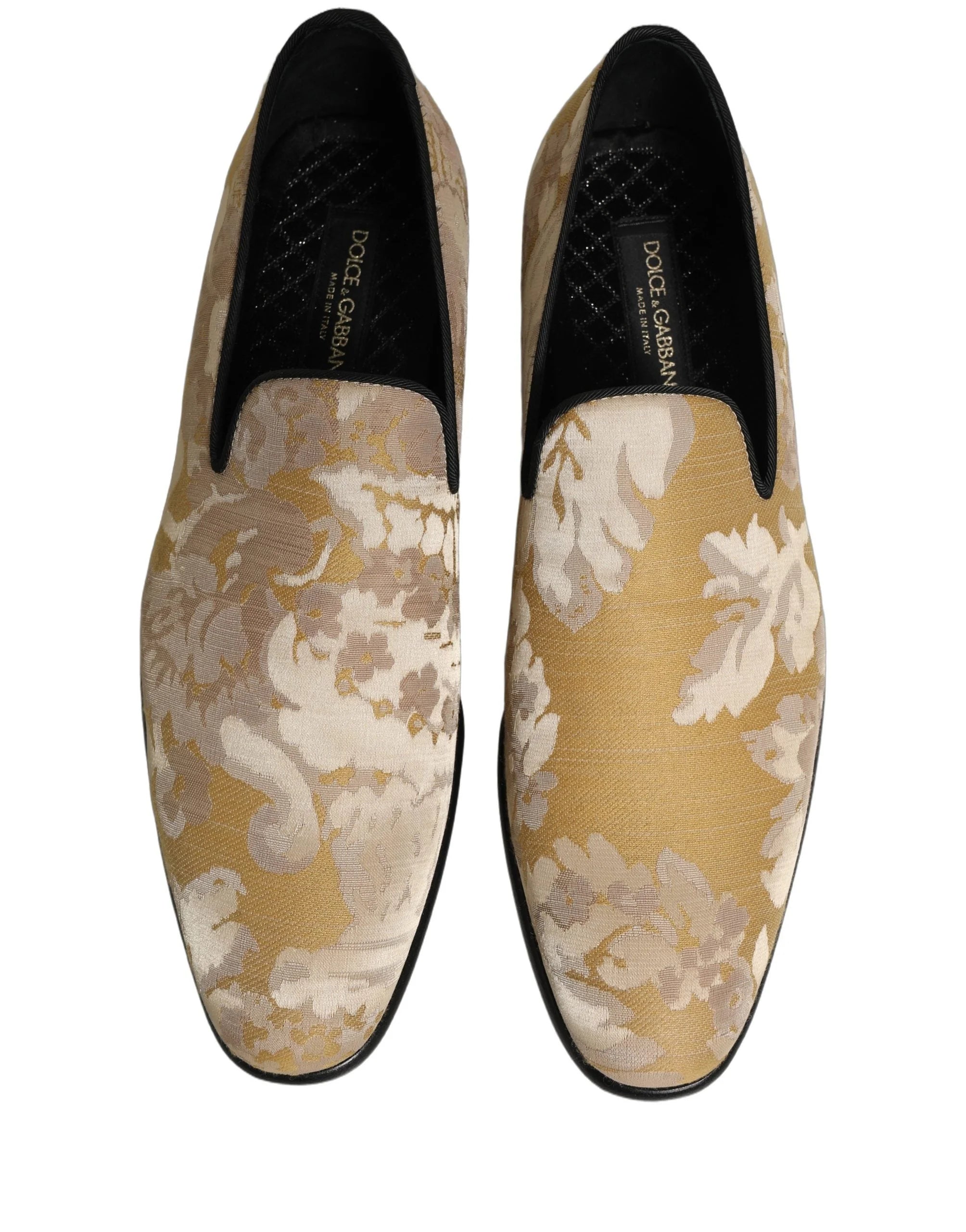 Side profile of Dolce & Gabbana gold jacquard loafers showcasing the intricate floral pattern and low stacked heel.