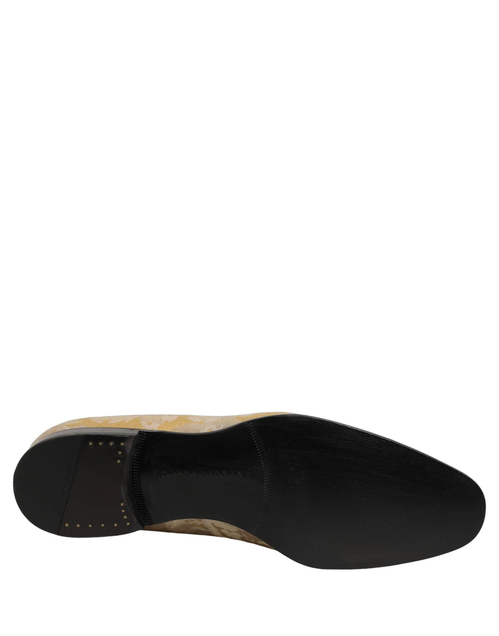 Pair of Dolce & Gabbana gold jacquard loafers presented in a formal studio setting, emphasizing luxury evening style.