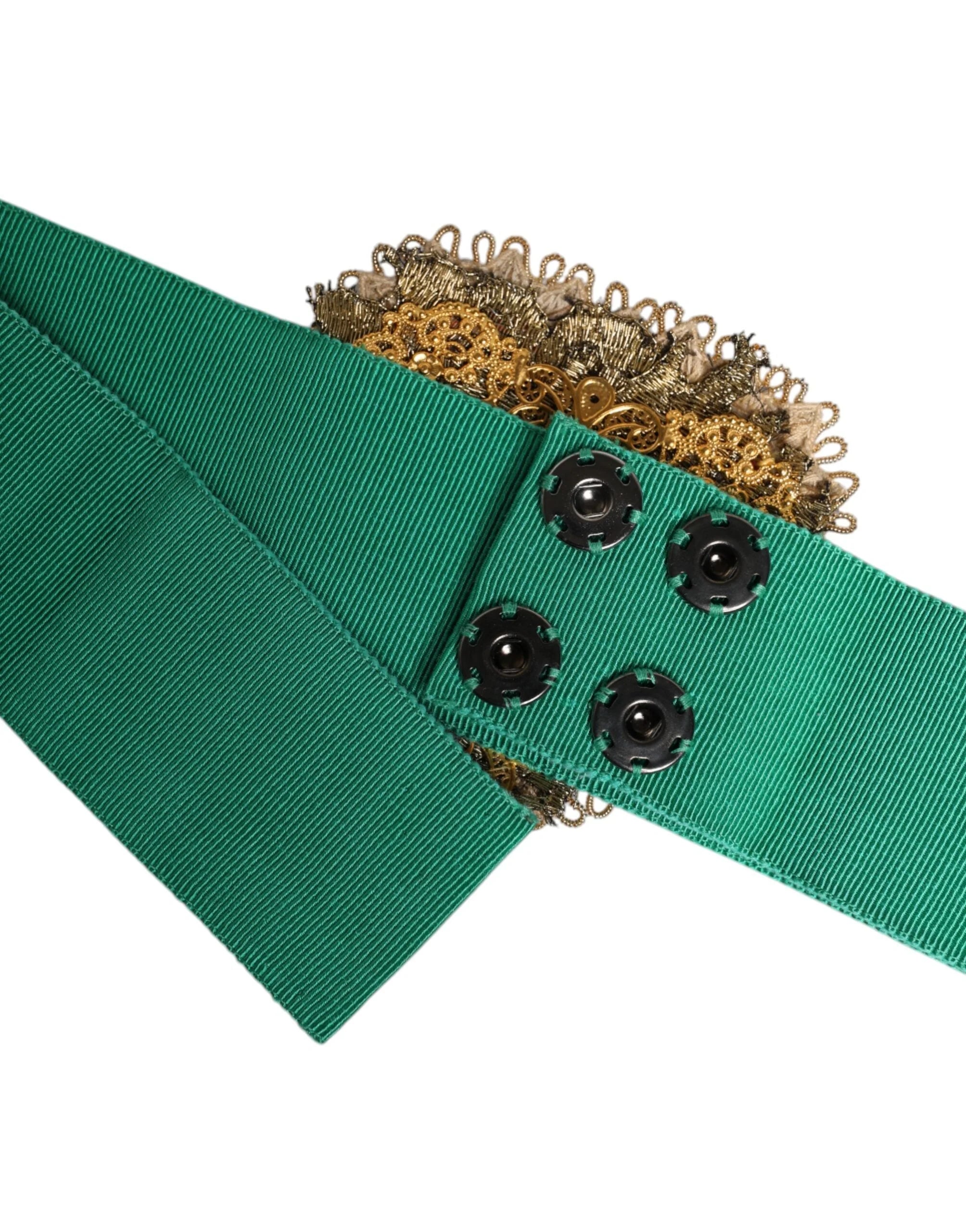 Close-up of the ornate gold-tone heart buckle on a Dolce & Gabbana green wide belt, showcasing intricate metalwork.