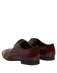 Ülaltvaade Dolce & Gabbana marooni kingadele, millel on keerukad kristallid toe ja paelte kohal.