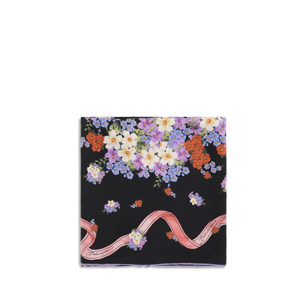 Vue frontale de l’écharpe en soie multicolore Dolce & Gabbana, présentant un imprimé floral éclatant et une bordure ornée.
