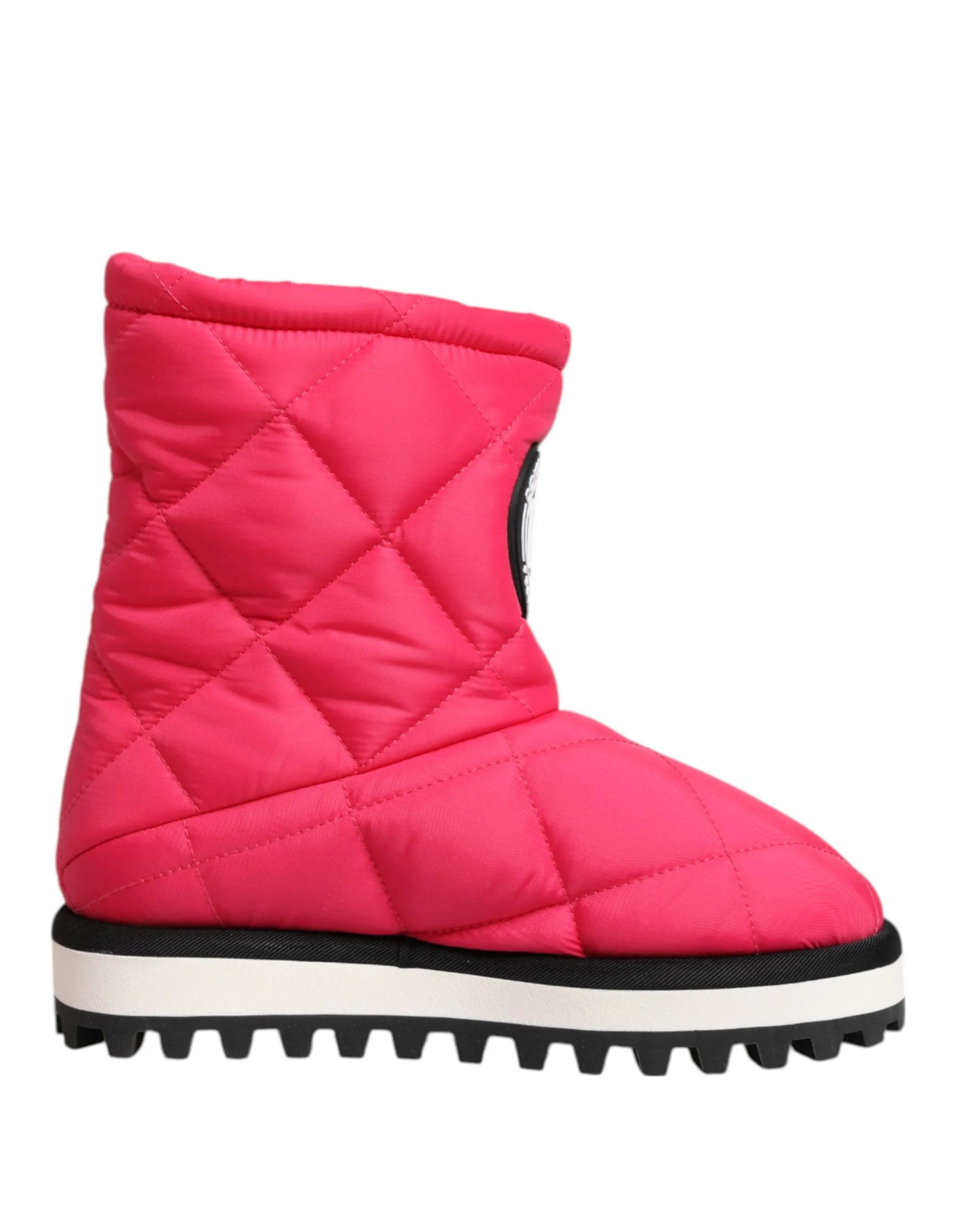 Detail shot of the quilted fuchsia fabric and precision stitching on Dolce & Gabbana luxury footwear.