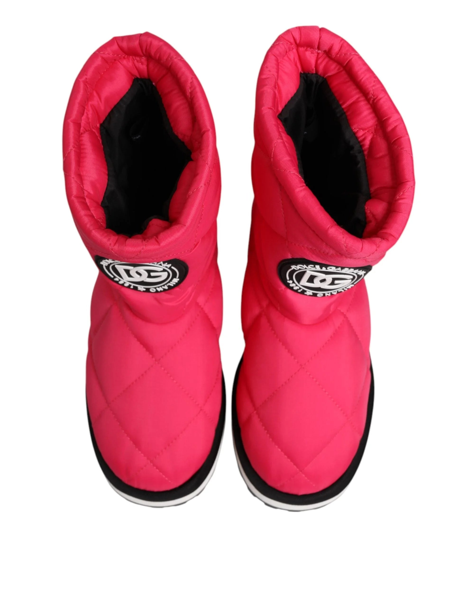 Side profile of Dolce & Gabbana pink padded boots showing the voluminous silhouette and contrast white trim.