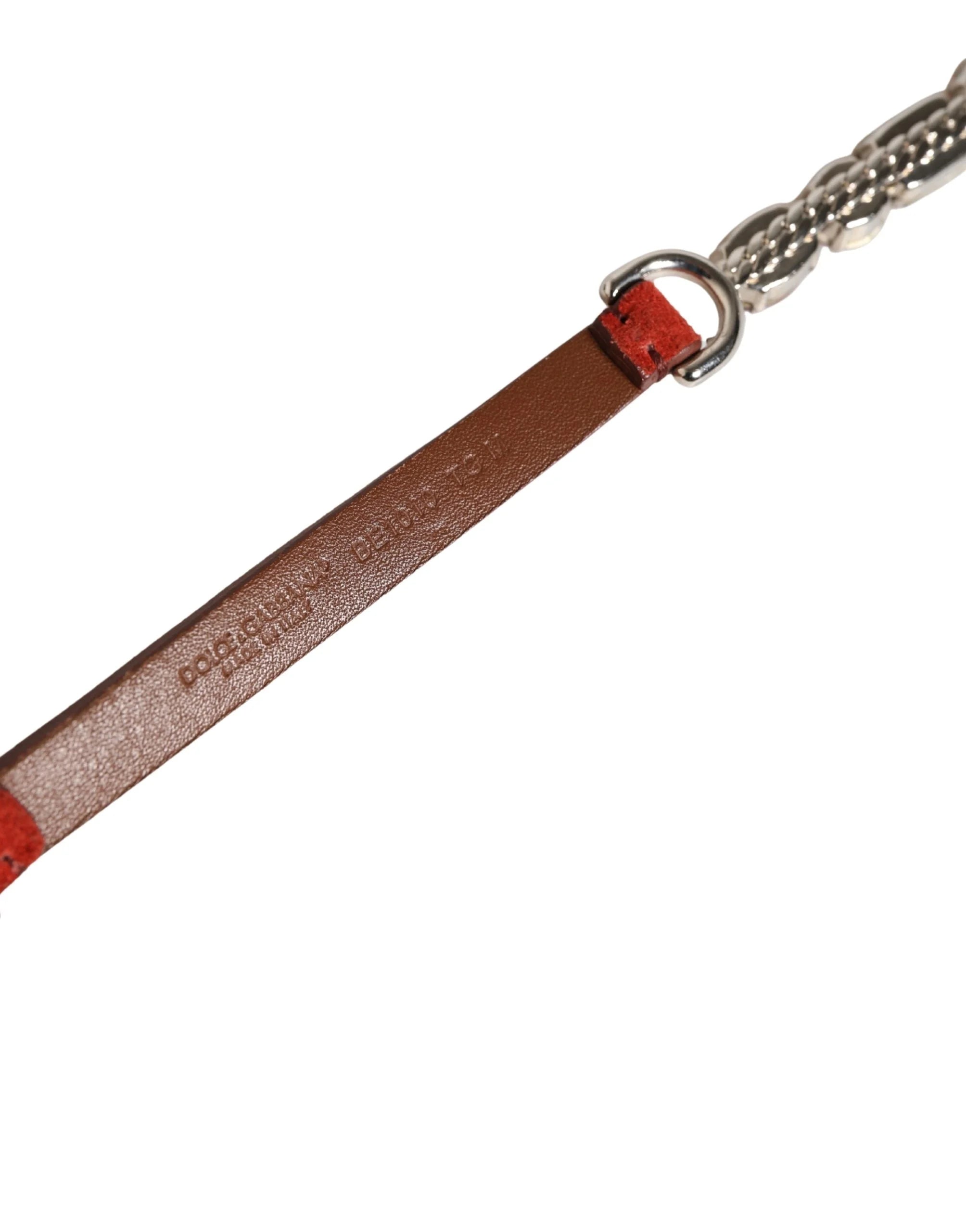 Macro view of the plush red velvet and artisanal metalwork defining this Dolce & Gabbana statement waist belt.
