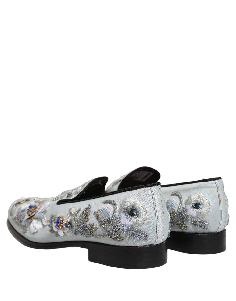 Toppvy av de vita läderinnersulorna och interiörmärkningen på Dolce & Gabbanas blommiga loafers.