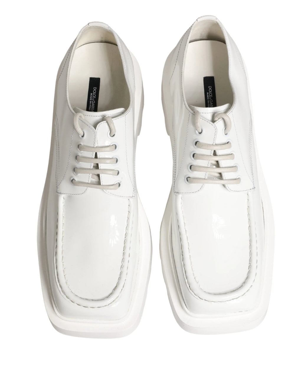 Side profile of Dolce & Gabbana white leather Derbies showing the architectural platform sole and clean silhouette.