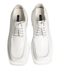 Side profile of Dolce & Gabbana white leather Derbies showing the architectural platform sole and clean silhouette.