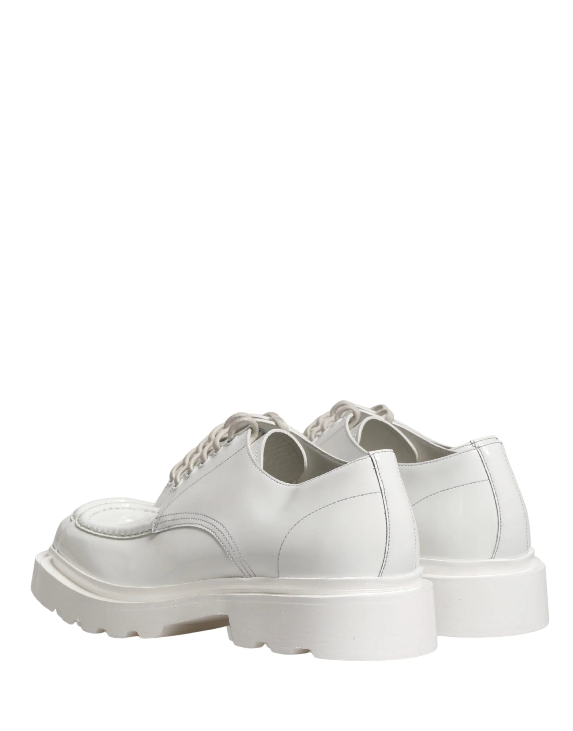 Top-down view of Dolce & Gabbana white leather Oxfords featuring a minimalist lacing system and smooth finish.