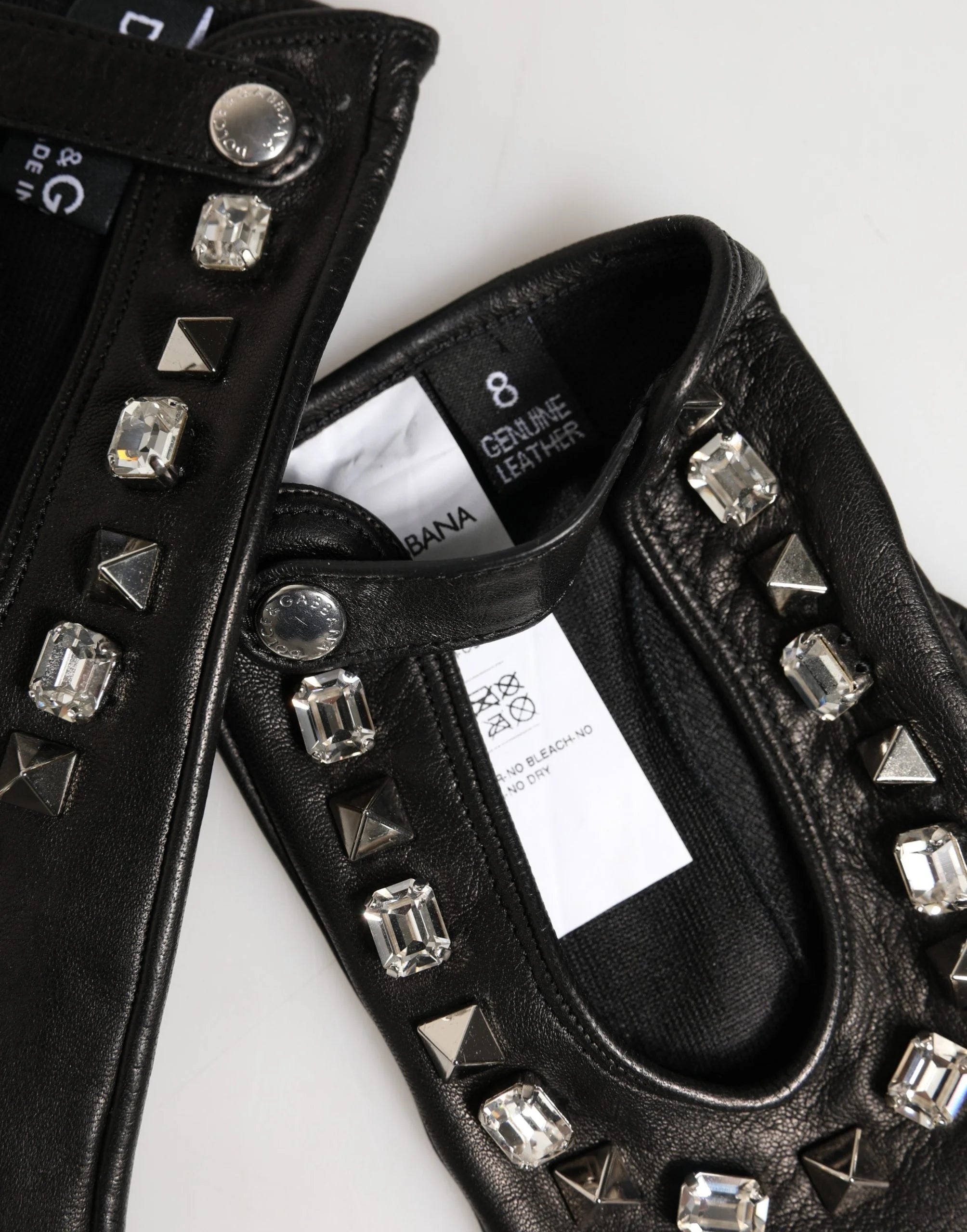 Detailed view of the interior lining and supple texture of the Dolce & Gabbana 100% lamb leather embellished mittens.