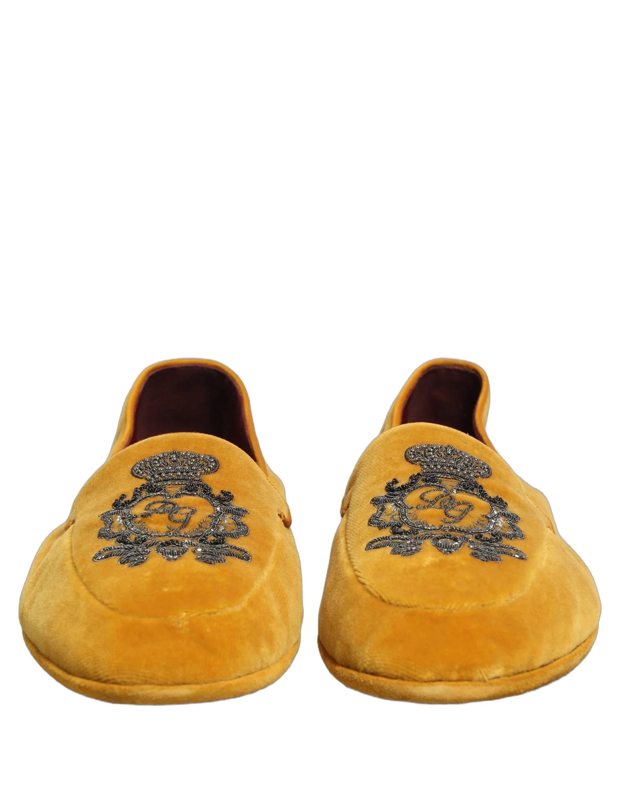 Side profile of Dolce & Gabbana yellow velvet loafers showing the sleek silhouette and black leather sole.