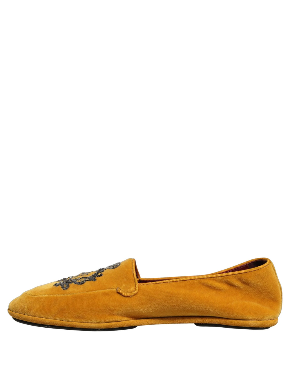 Detail shot of the plush yellow velvet texture and precise stitching on the Dolce & Gabbana men's evening loafers.