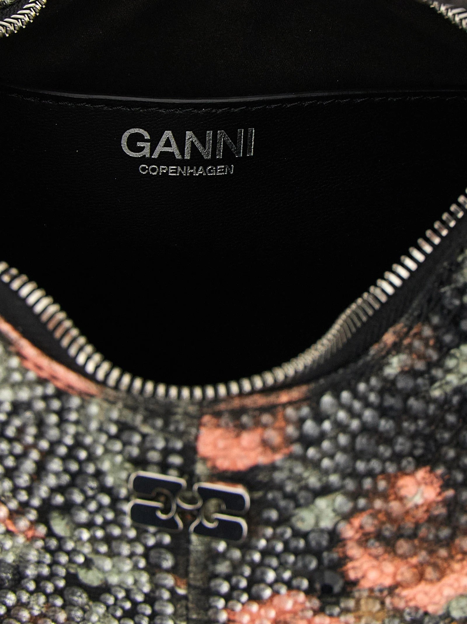 Close-up of the Ganni handbag's cotton fabric texture and precise stitching, reflecting the brand's craft heritage.