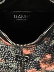 Close-up of the Ganni handbag's cotton fabric texture and precise stitching, reflecting the brand's craft heritage.