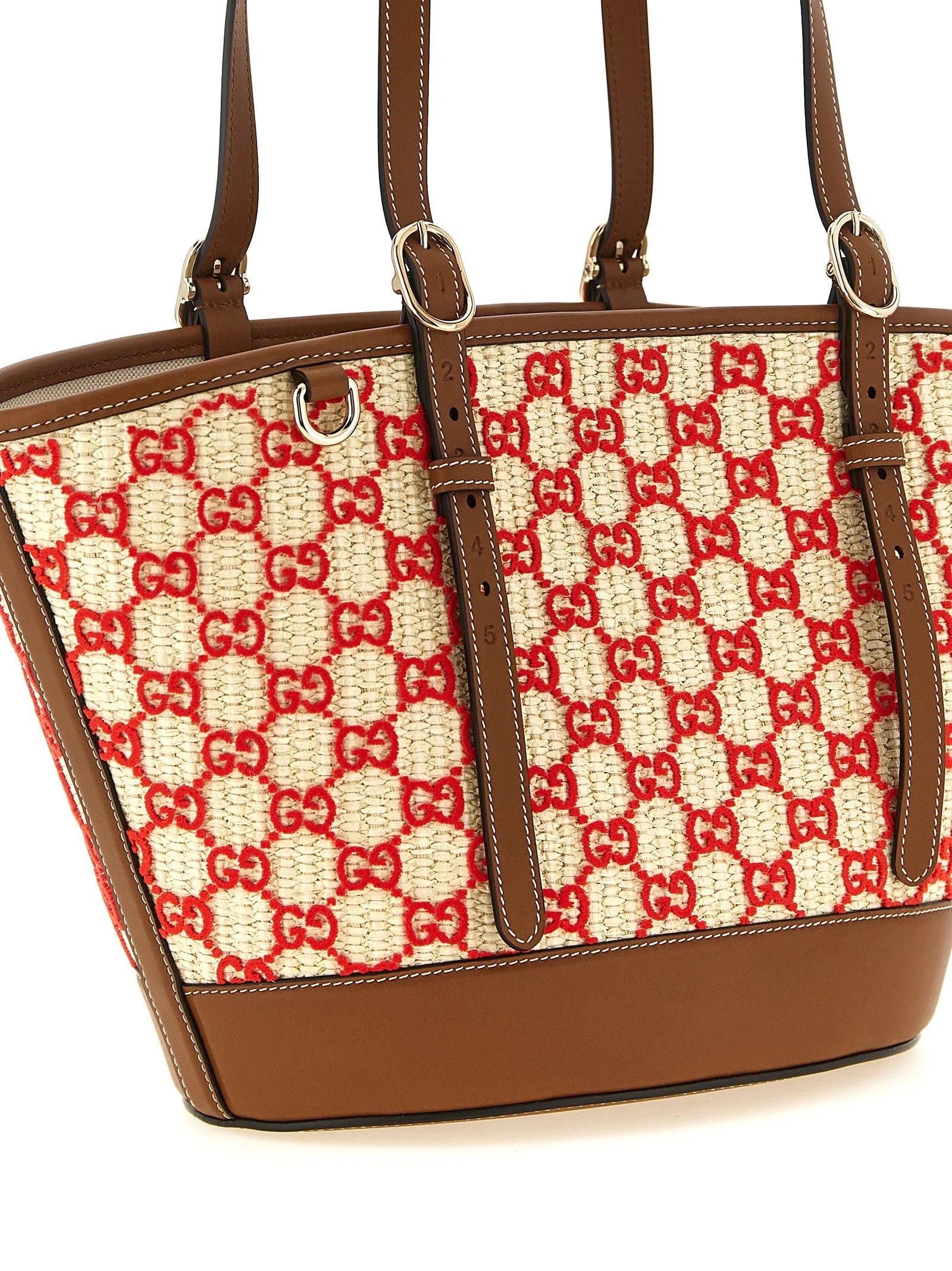 Zadní pohled na tote bag Gucci s víceramenným vzorem, zdůrazňující kontinuální textilní vzor a rafinovanou povrchovou úpravu.