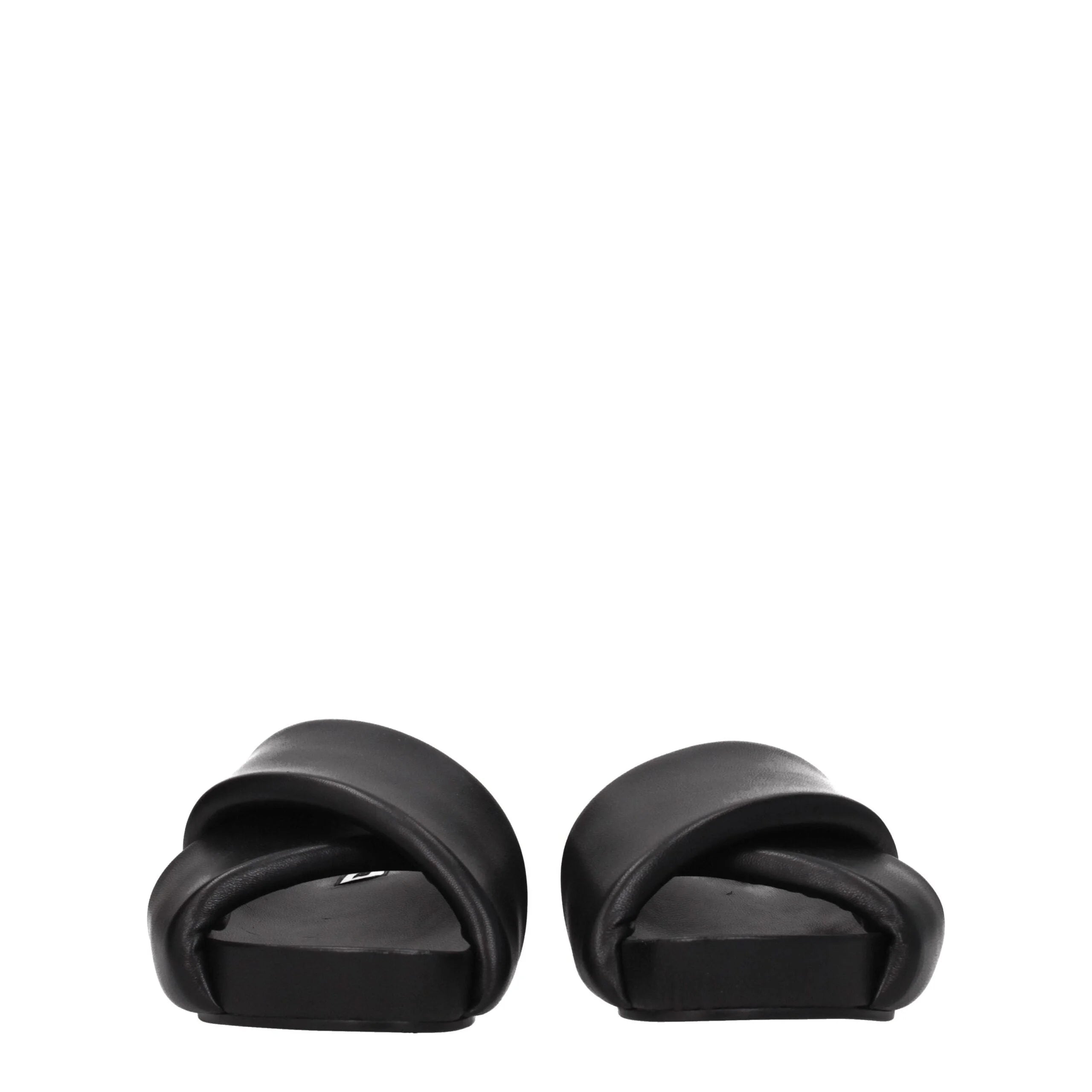 Vue arrière des pantoufles plates en cuir Jil Sander, mettant en valeur les lignes épurées et la finition lisse et mate du talon.