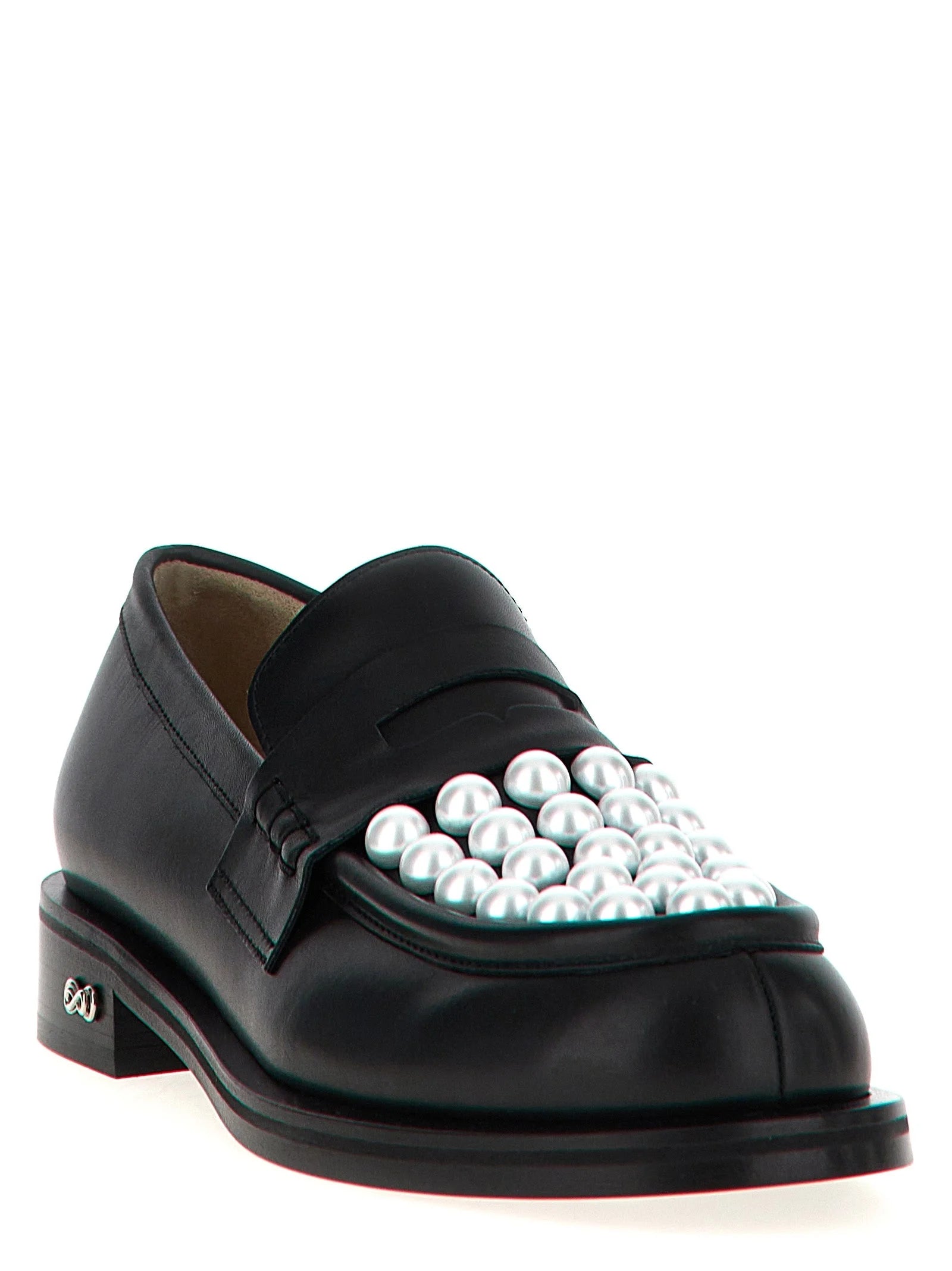 Side profile of MACH & MACH bicolor loafers showing the contrast between the white upper and black leather sole.
