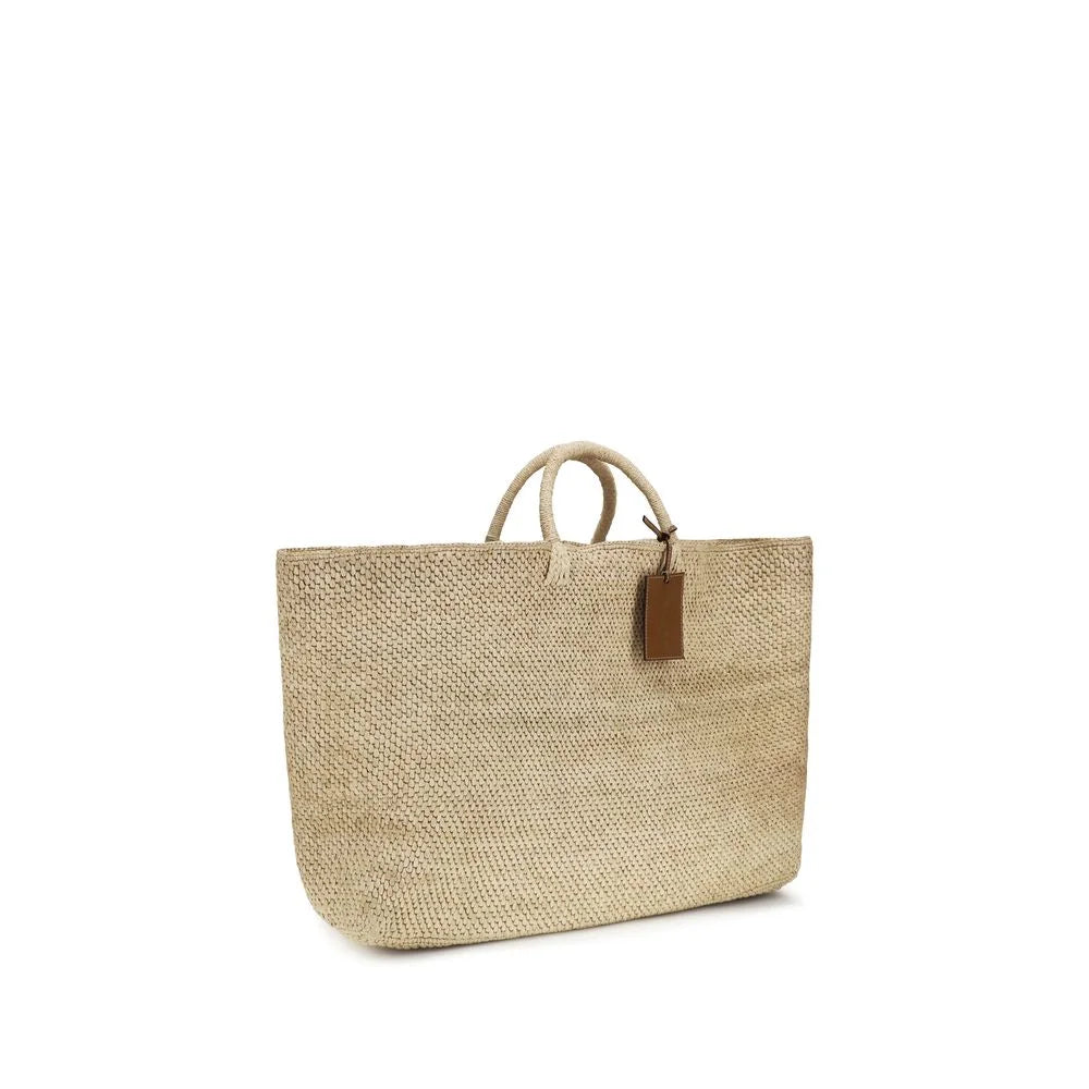 Side profile of the Manebi raffia tote bag in neutral beige, showcasing the depth and natural fiber construction.
