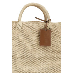 Close-up of the Manebi raffia handbag texture, revealing the intricate weave and premium natural material detail.