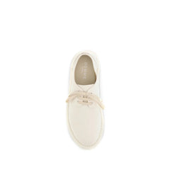 Close-up of Marsell white cotton and leather oxfords showcasing the fine grain texture and precise lacing detail.
