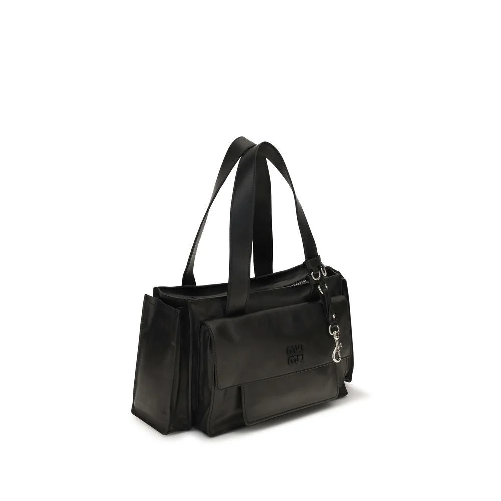 Side profile of the Miu Miu Bos Taurus bag in rich brown leather, highlighting the slender strap and refined edges.