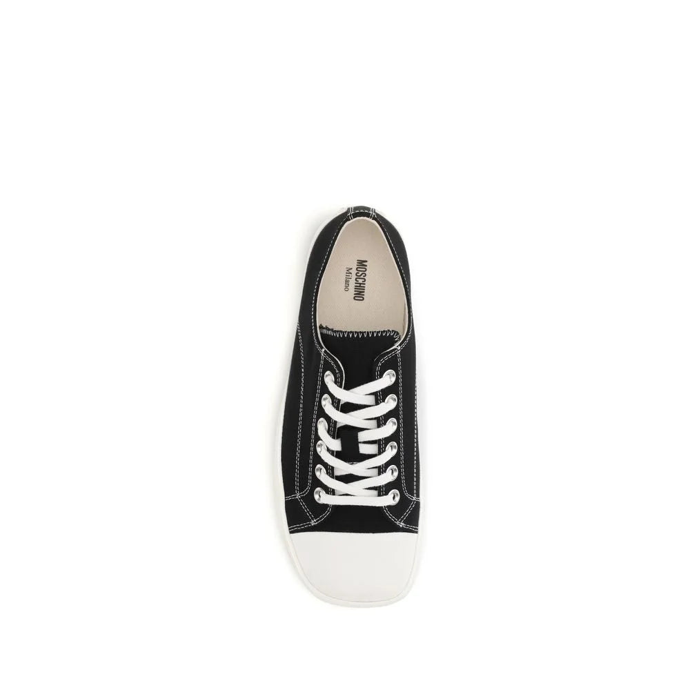 Close-up of the premium black cotton canvas texture and stitching details on these Moschino luxury low top shoes.